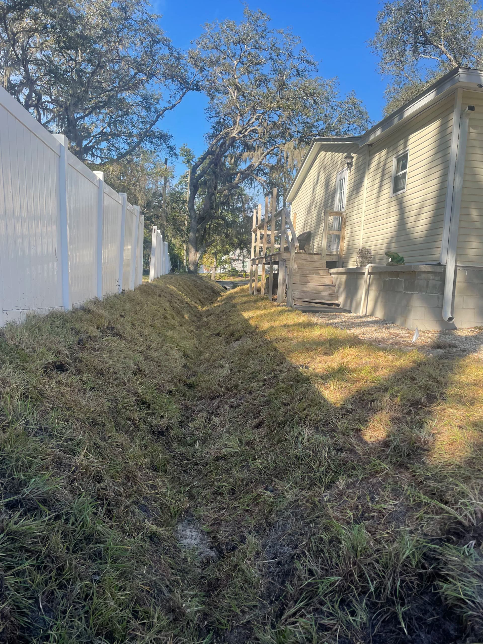 Drainage Line Restoration and Sod Installation After 30 Years of Washout image